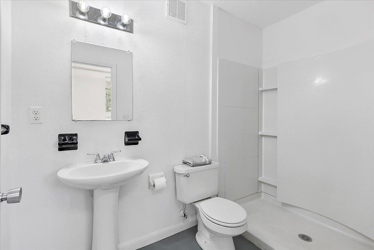 108 Ferrol Road St. Augustine, FL 32084 - Photo 29 of 39 a bathroom with a toilet sink and mirror