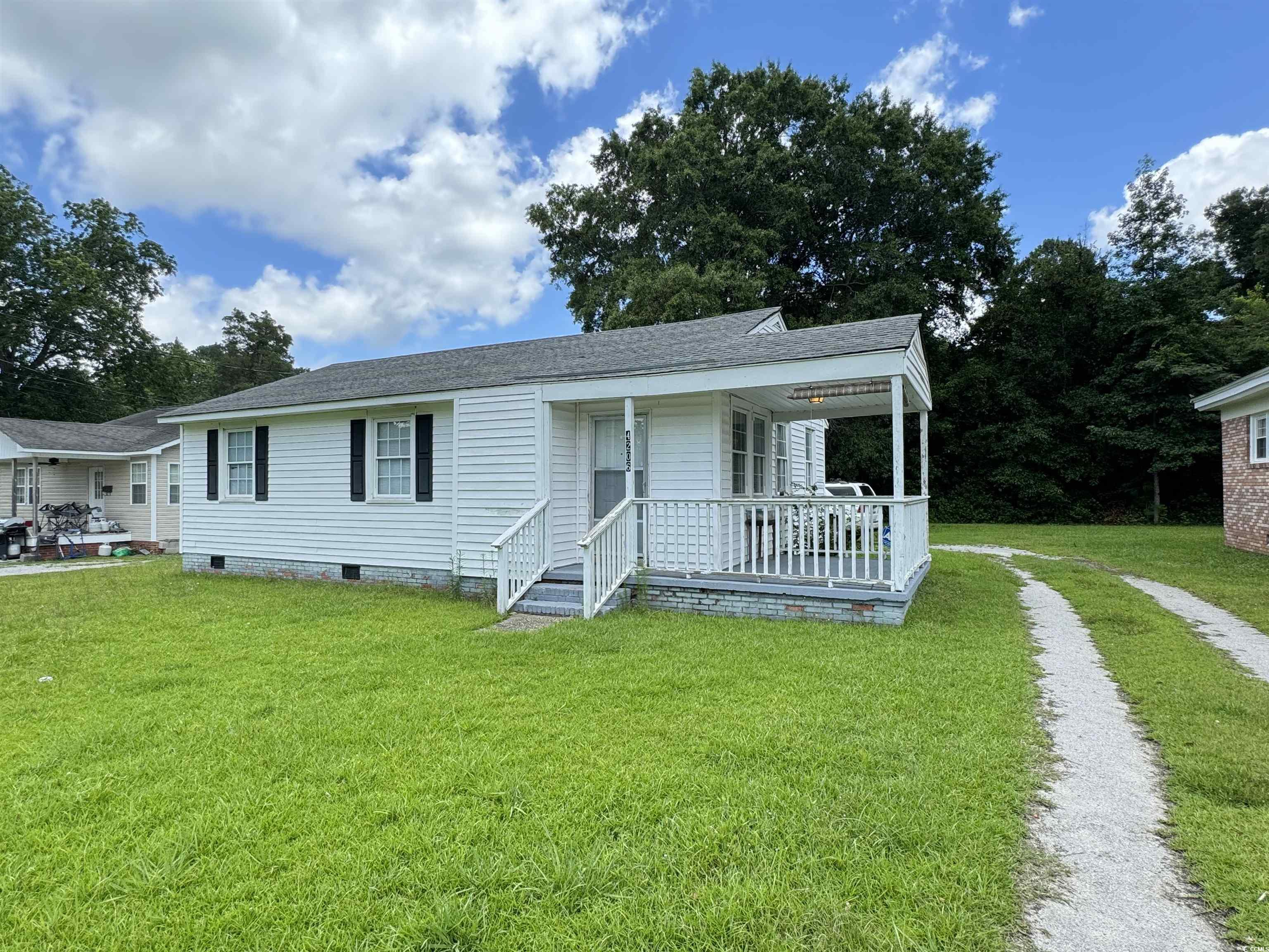 4206 Stevens Street Loris, SC 29569 - Photo 1 of 10 View of front facade with crawl space, a front lawn, and a shingled roof