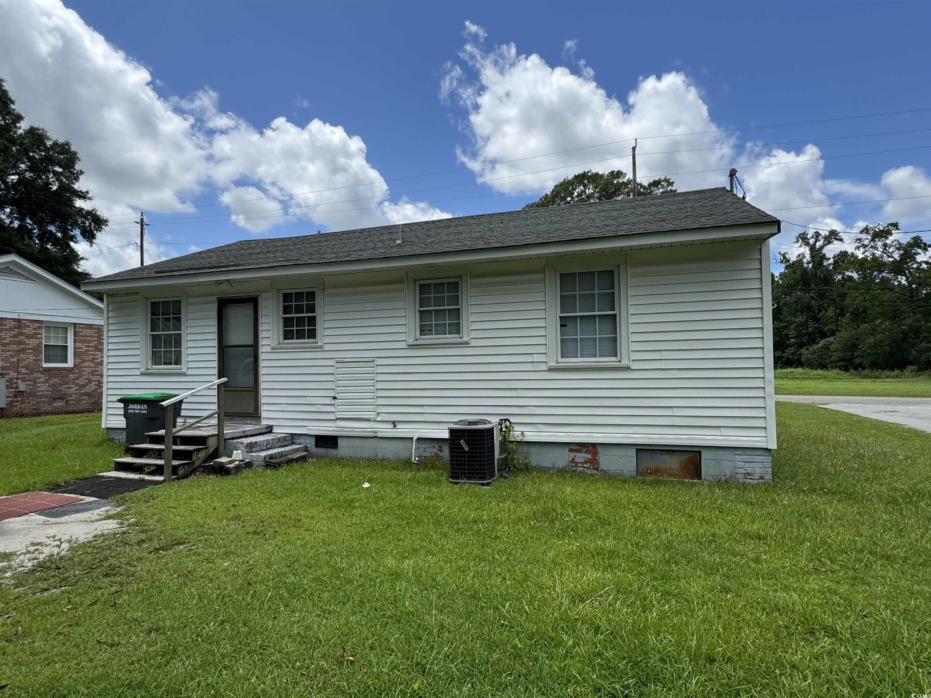 4206 Stevens Street Loris, SC 29569 - Photo 2 of 10 Rear view of house with crawl space, a yard, a shingled roof, and entry steps