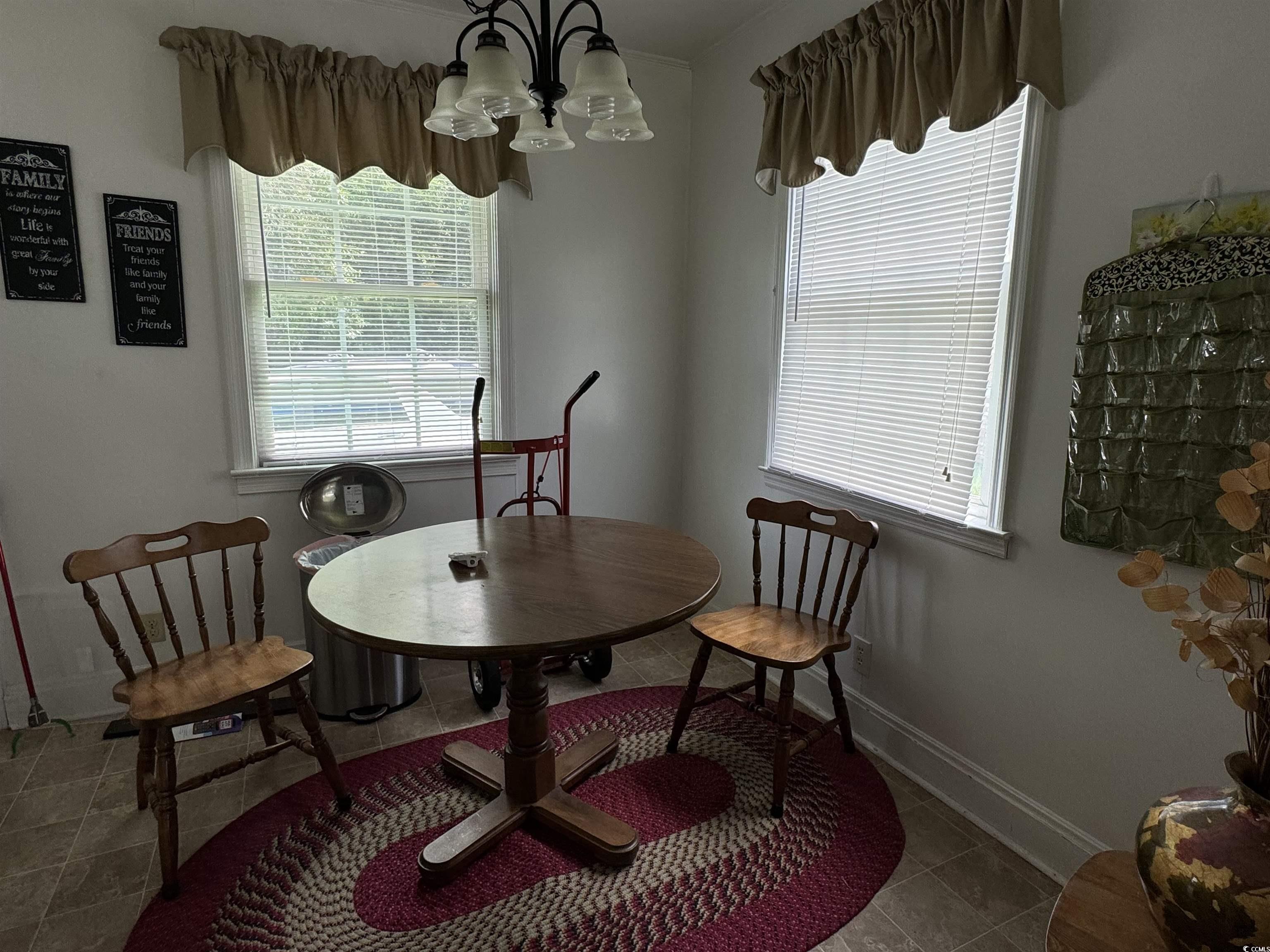 4206 Stevens Street Loris, SC 29569 - Photo 7 of 10 Dining room featuring a chandelier, plenty of natural light, and light tile patterned floors