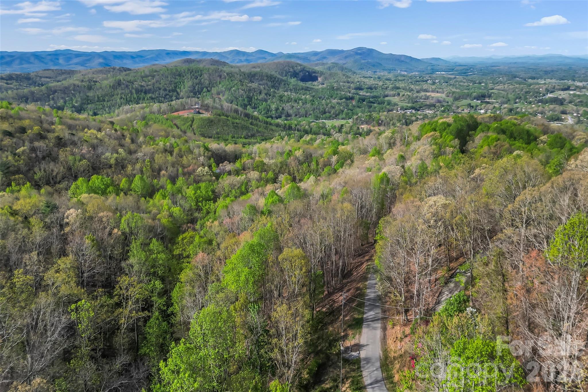 0 High Peak Mountain Road Valdese, NC 28690 - Photo 2 of 15 a view of a lush green hillside and a houses