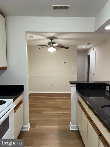 a kitchen with granite countertop a sink and a stove top oven