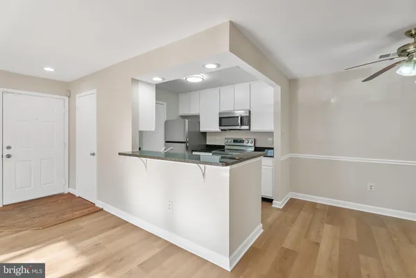 a kitchen with stainless steel appliances a refrigerator sink and microwave