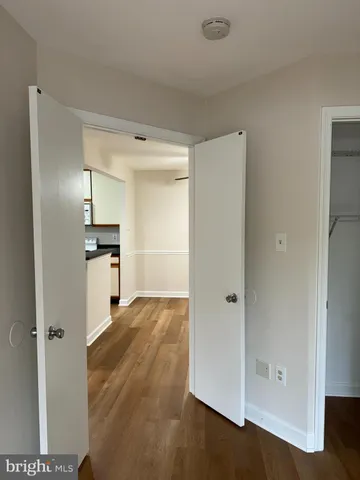 a view of a kitchen with wooden floor and electronic appliances