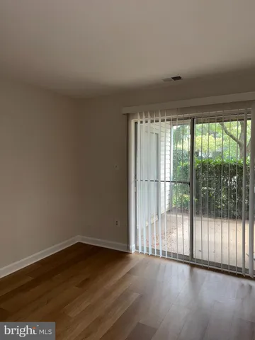 a view of wooden floor and windows in a room