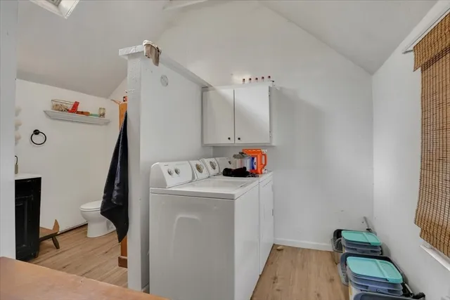 a storage room with wooden floor and cabinets