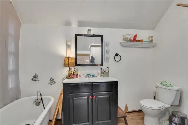 a bathroom with a sink vanity mirror and toilet