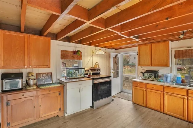 a kitchen with lots of counter top space and wooden floor