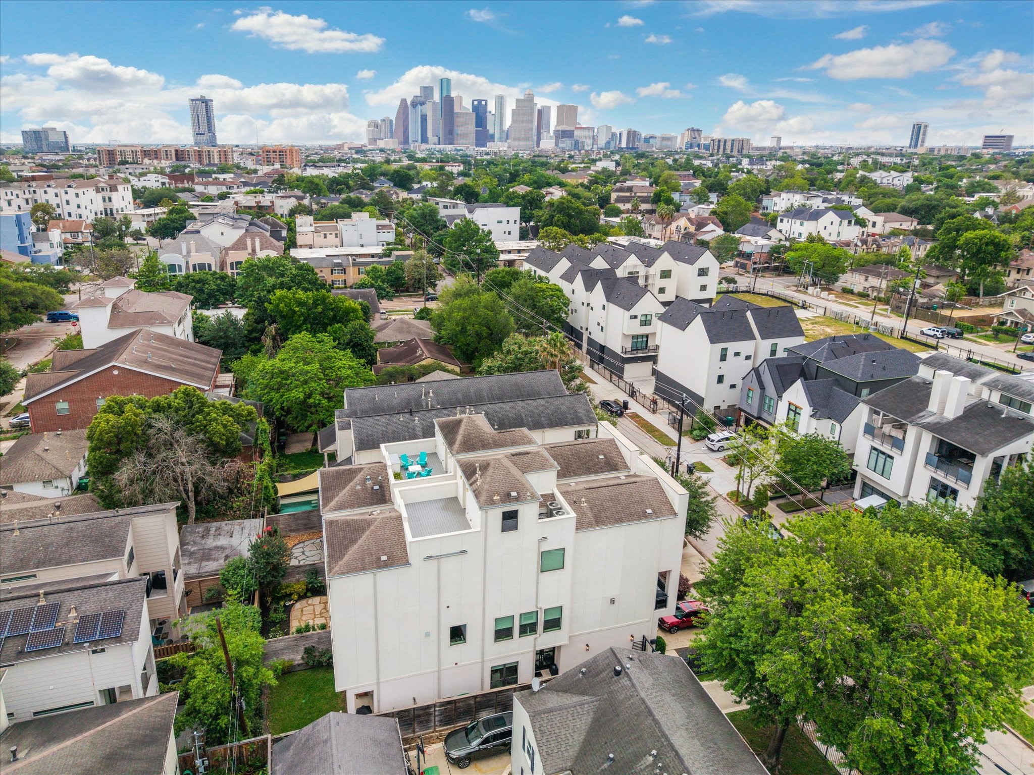 1526 Vermont Street Houston, TX 77006 - Photo 2 of 39 Aerial view showcasing the home’s rooftop terrace and prime Montrose location with Downtown Houston skyline views.
