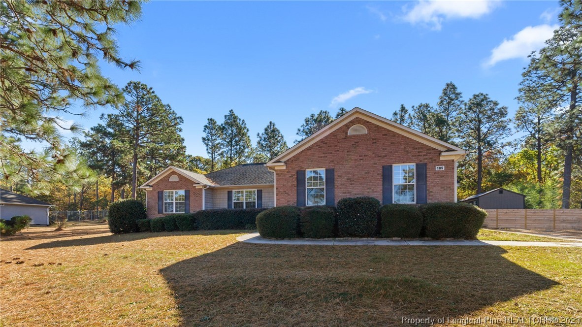 185 Russet Court Carthage, NC 28327 - Photo 1 of 32 a front view of house with yard and trees in the background
