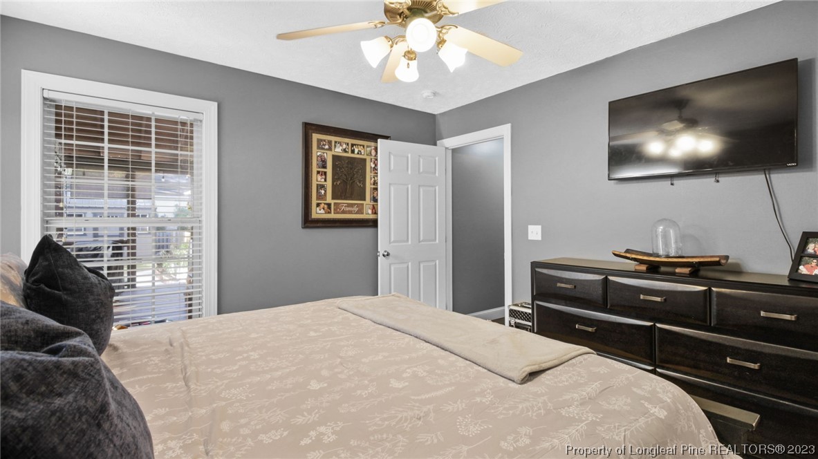 185 Russet Court Carthage, NC 28327 - Photo 16 of 32 a bedroom with a bed and a flat screen tv
