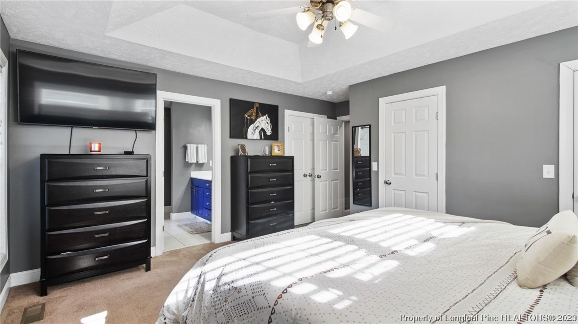 185 Russet Court Carthage, NC 28327 - Photo 23 of 32 a bedroom with a bed and dresser