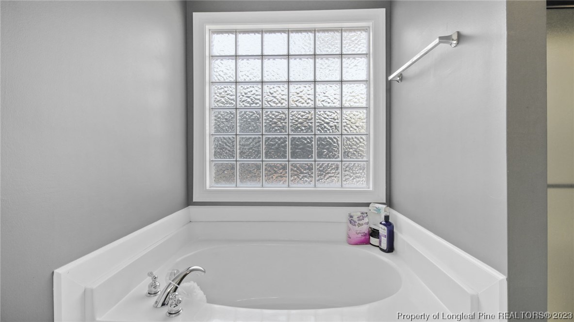 185 Russet Court Carthage, NC 28327 - Photo 25 of 32 a white bath tub sitting in a bathroom next to a window