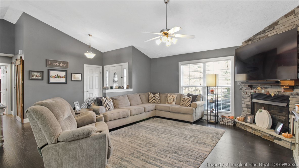 185 Russet Court Carthage, NC 28327 - Photo 5 of 32 a living room with furniture a fireplace and a flat screen tv