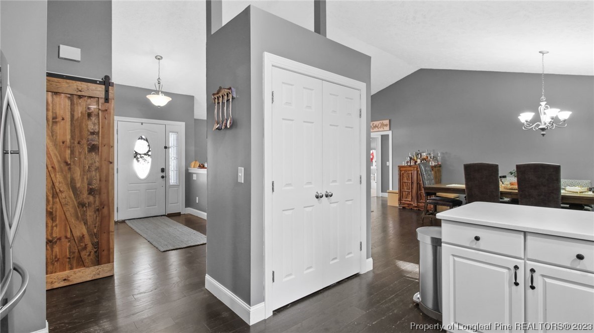 185 Russet Court Carthage, NC 28327 - Photo 10 of 32 a kitchen with a refrigerator and chandelier