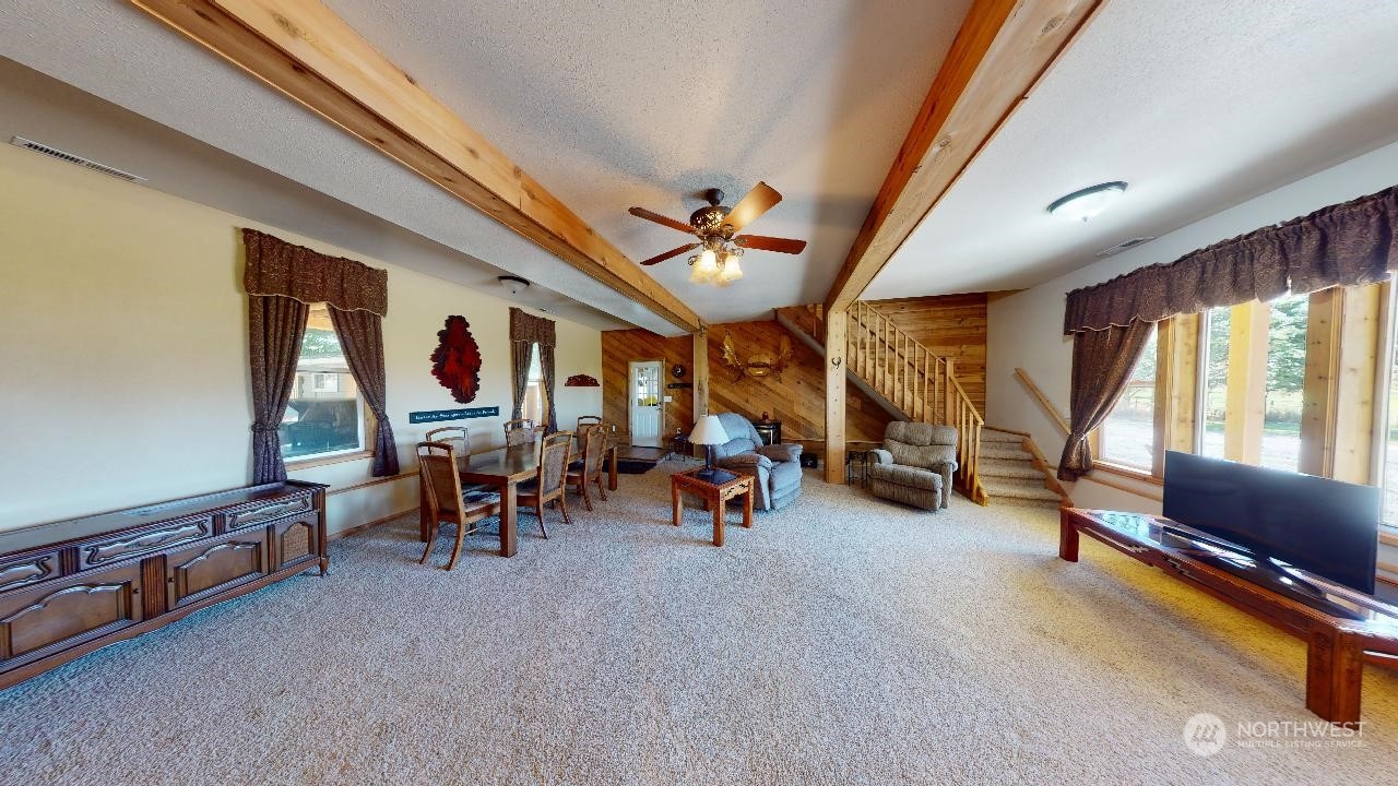 216 Tucannon Road Dayton, WA 99328 - Photo 12 of 39 a living room with furniture gym equipment and a large window
