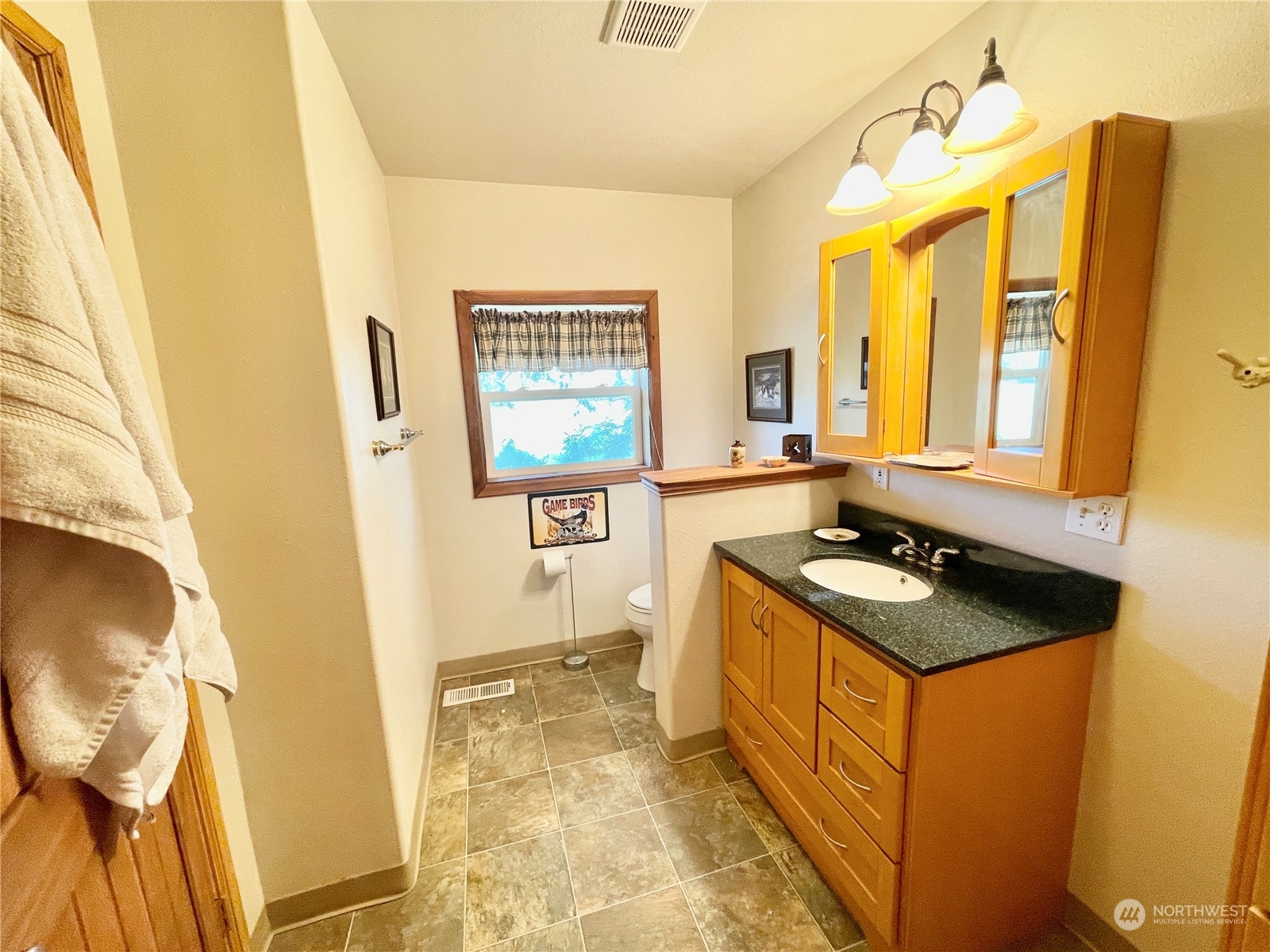 216 Tucannon Road Dayton, WA 99328 - Photo 18 of 39 a bathroom with a granite countertop sink and a mirror