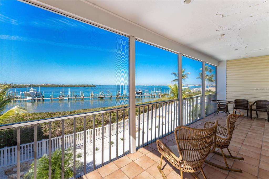 1400 Beach Road, Unit 1 Englewood, FL 34223 - Photo 13 of 68 a view of a balcony with chair and floor to ceiling window