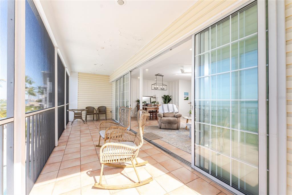 1400 Beach Road, Unit 1 Englewood, FL 34223 - Photo 15 of 68 a dining room with furniture and a floor to ceiling window