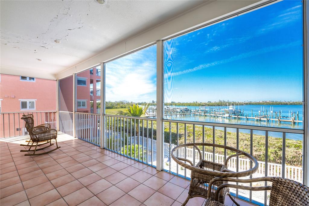 1400 Beach Road, Unit 1 Englewood, FL 34223 - Photo 16 of 68 a view of a balcony with chair and table