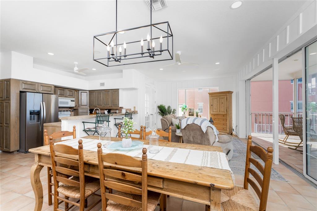 1400 Beach Road, Unit 1 Englewood, FL 34223 - Photo 20 of 68 a view of a dining room with furniture a chandelier and kitchen view