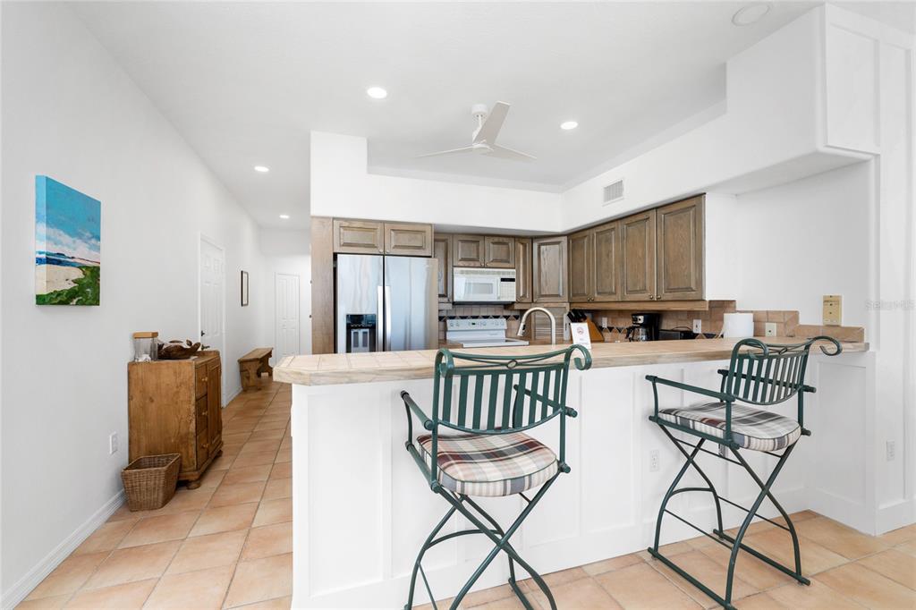 1400 Beach Road, Unit 1 Englewood, FL 34223 - Photo 21 of 68 a living room with furniture a kitchen view and a kitchen counter top space