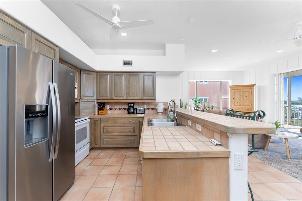 1400 Beach Road, Unit 1 Englewood, FL 34223 - Photo 22 of 68 a kitchen with a sink stainless steel appliances and cabinets