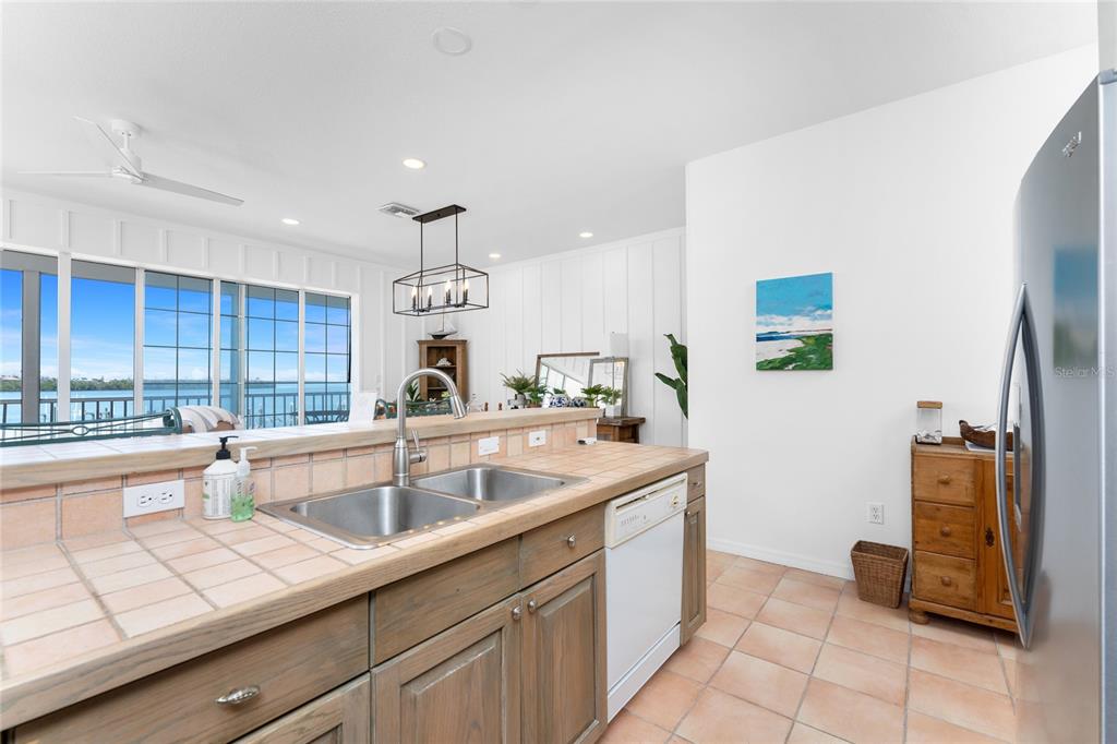 1400 Beach Road, Unit 1 Englewood, FL 34223 - Photo 25 of 68 a kitchen with a sink and a refrigerator