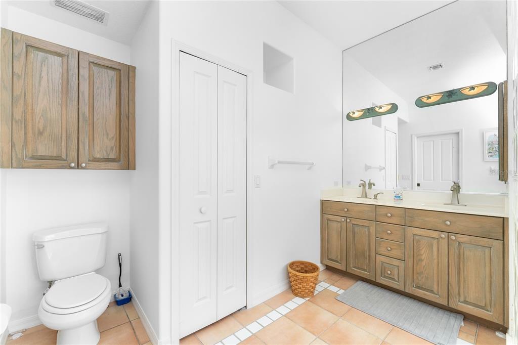 1400 Beach Road, Unit 1 Englewood, FL 34223 - Photo 31 of 68 a spacious bathroom with a double vanity sink a toilet and a mirror
