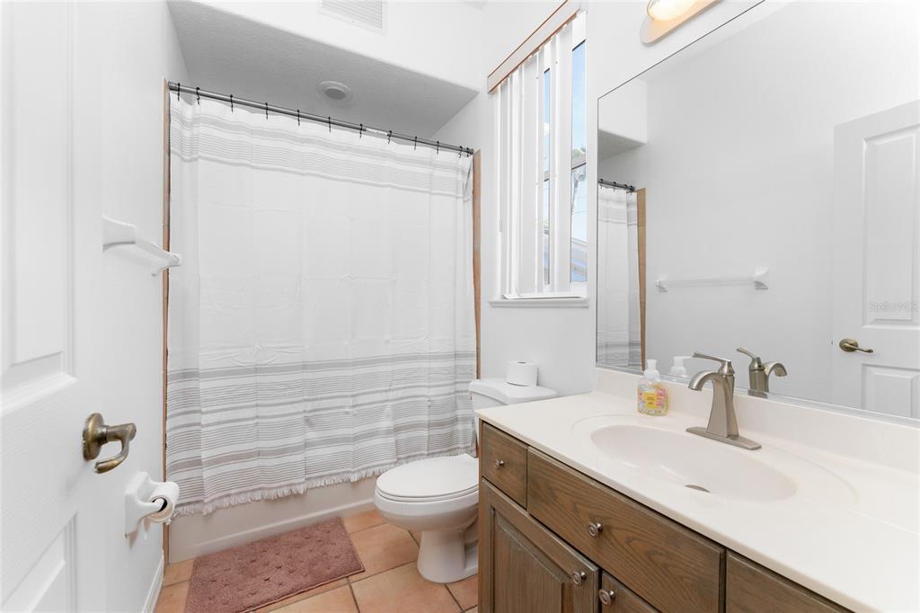 1400 Beach Road, Unit 1 Englewood, FL 34223 - Photo 37 of 68 a bathroom with a sink a toilet a mirror and shower