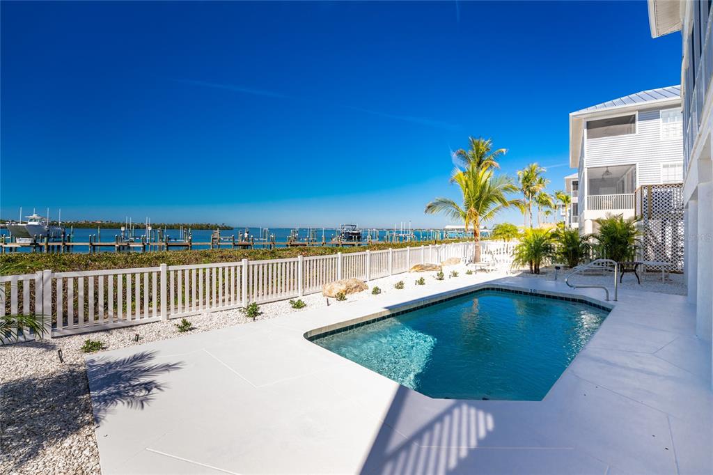 1400 Beach Road, Unit 1 Englewood, FL 34223 - Photo 46 of 68 a view of a swimming pool with outdoor seating