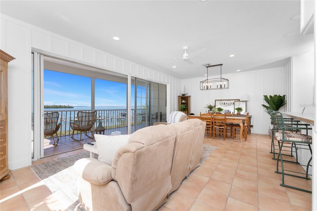1400 Beach Road, Unit 1 Englewood, FL 34223 - Photo 9 of 68 a living room with furniture a dining table and a large window