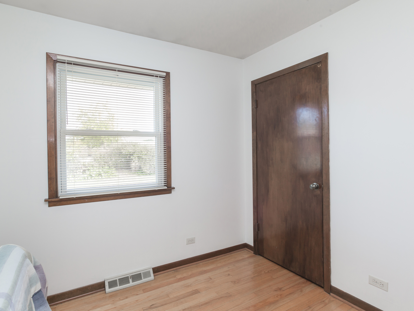 111 East Devon Avenue Bartlett, IL 60103 - Photo 13 of 20 a view of an empty room with wooden floor and a window