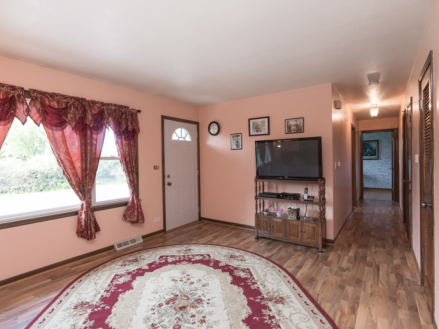 111 East Devon Avenue Bartlett, IL 60103 - Photo 5 of 20 a living room with a bed furniture and a flat screen tv