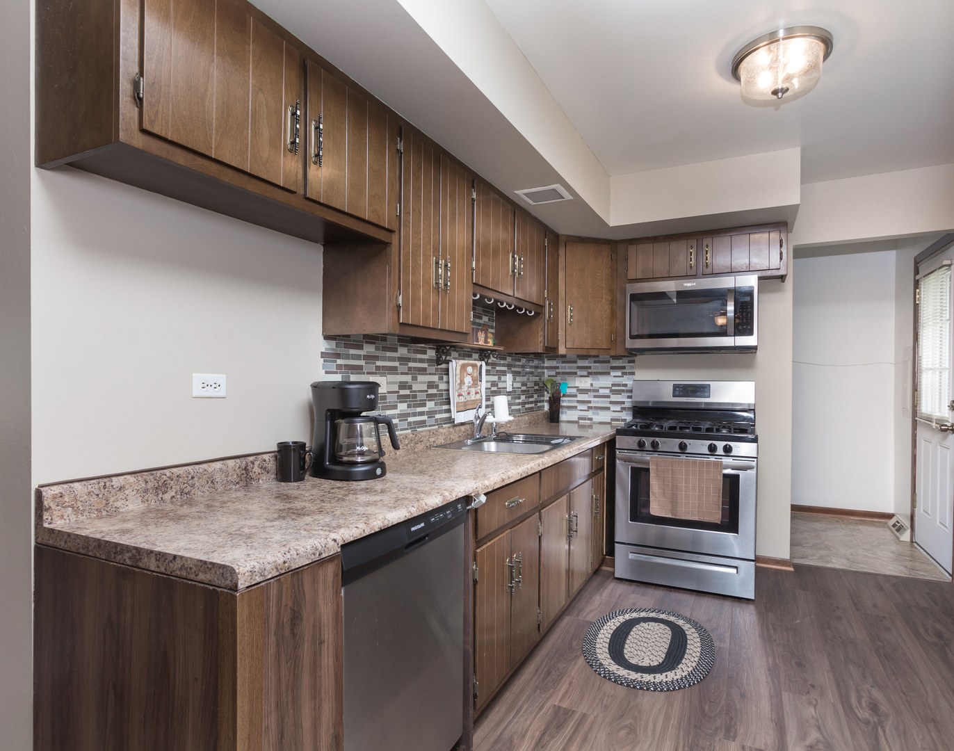 111 East Devon Avenue Bartlett, IL 60103 - Photo 6 of 20 a kitchen with granite countertop stainless steel appliances and wooden cabinets