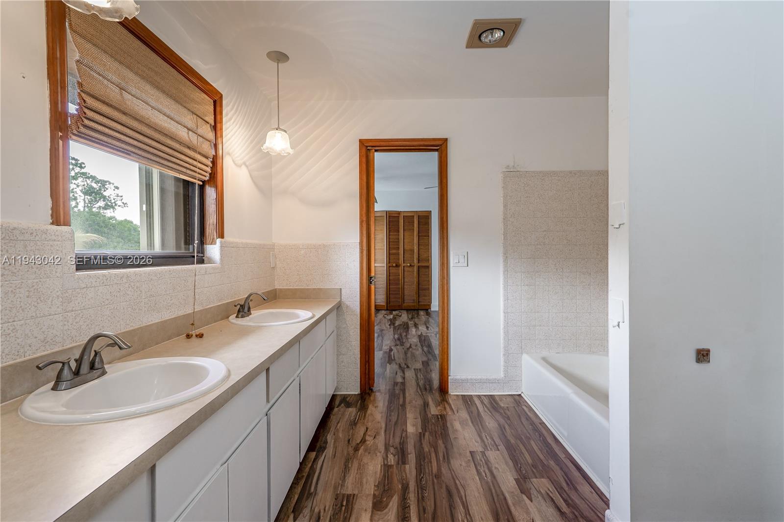 576 Marshall Road West Palm Beach, FL 33413 - Photo 18 of 44 a bathroom with a double vanity sink and mirror with shower