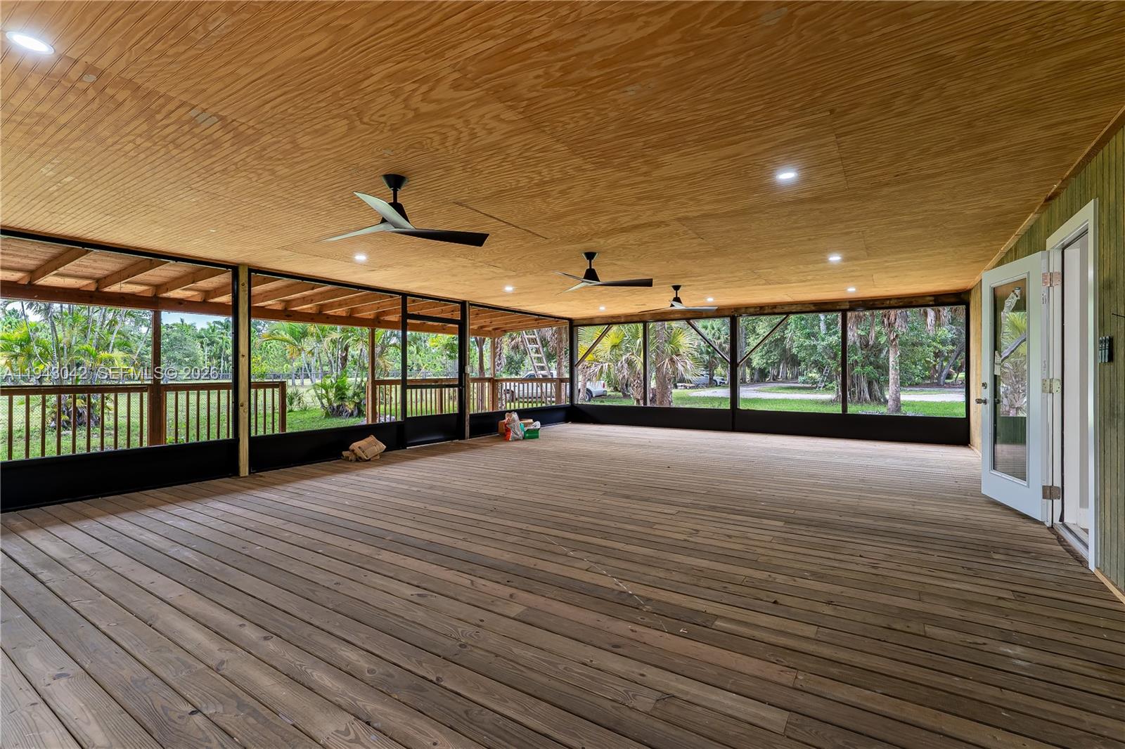 576 Marshall Road West Palm Beach, FL 33413 - Photo 33 of 44 a view of an empty room with wooden floor and a balcony