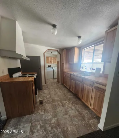 a kitchen with sink cabinets and window