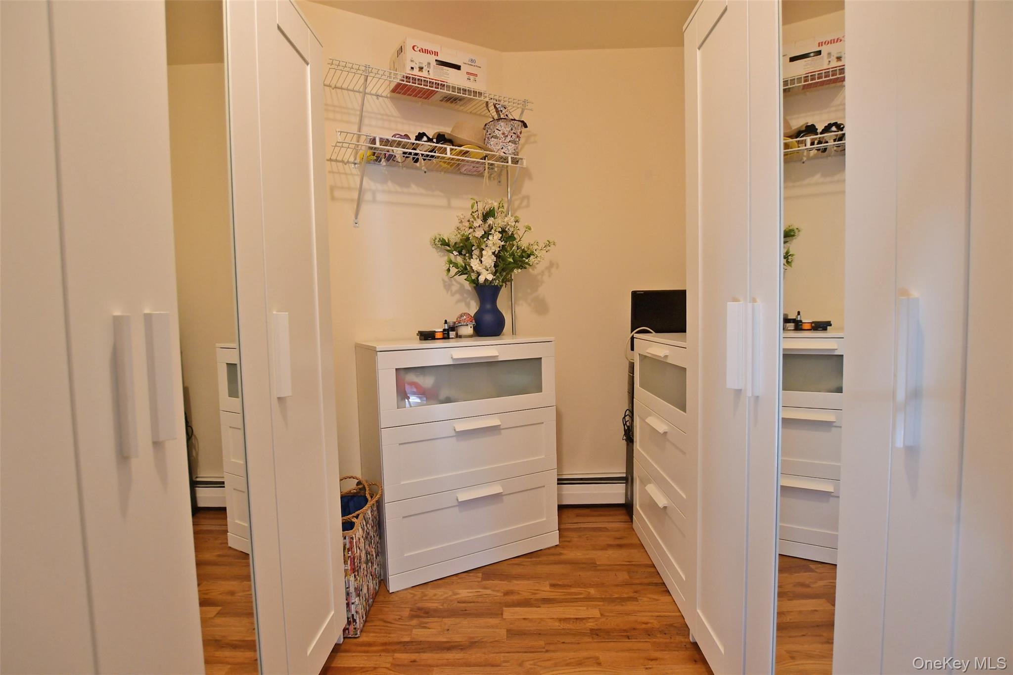 64 Glen Road Baiting Hollow, NY 11933 - Photo 19 of 46 Corridor featuring light wood finished floors and a baseboard heating unit