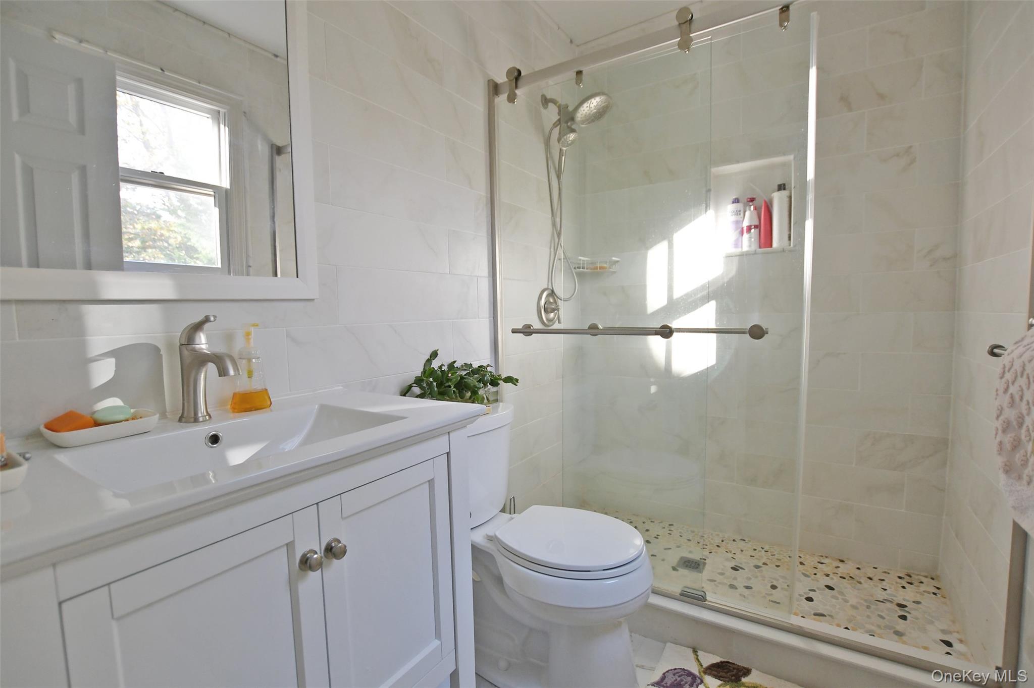64 Glen Road Baiting Hollow, NY 11933 - Photo 20 of 46 Full bath featuring tile walls, vanity, a stall shower, and tasteful backsplash