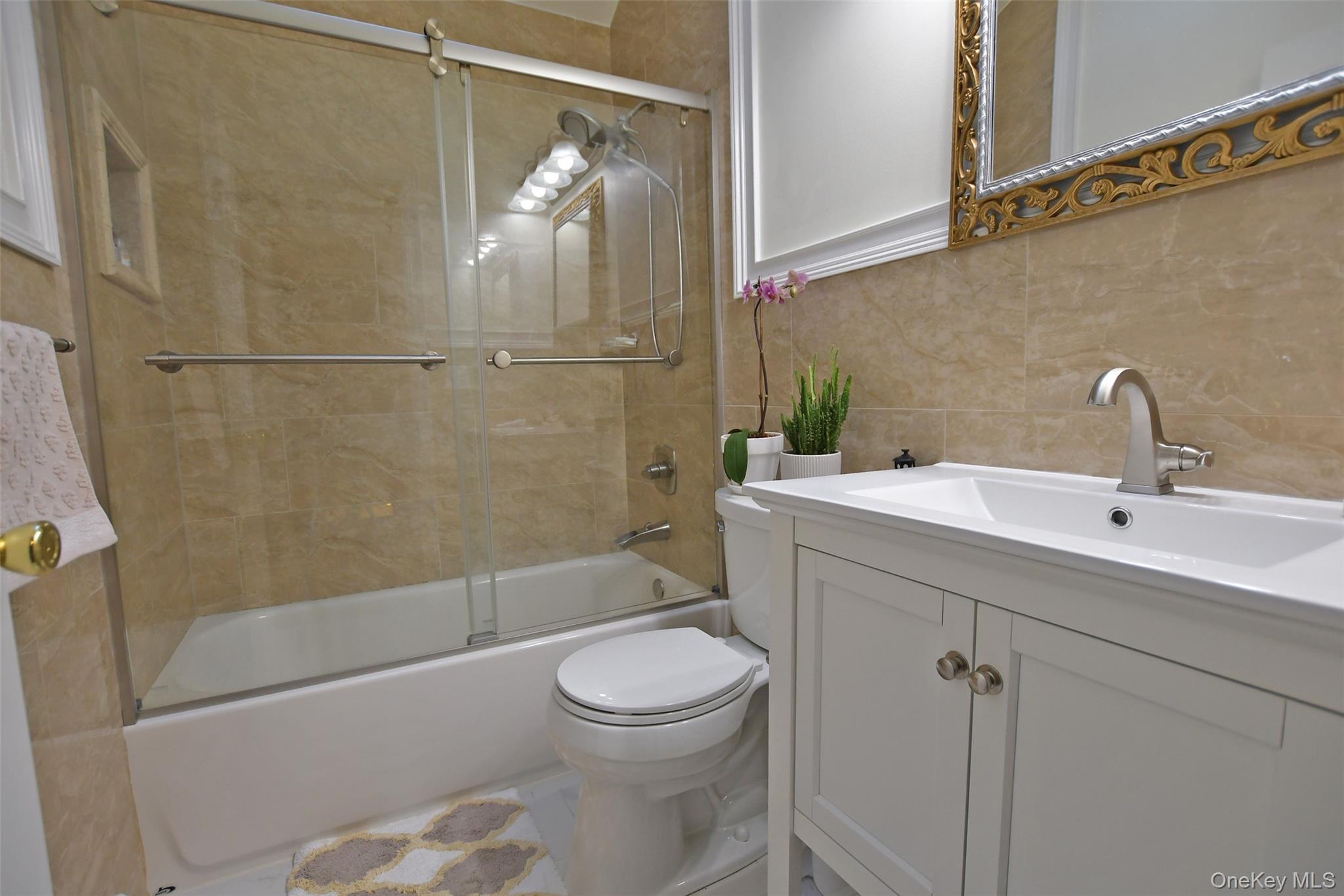 64 Glen Road Baiting Hollow, NY 11933 - Photo 24 of 46 Full bathroom featuring vanity, combined bath / shower with glass door, tile walls, and backsplash