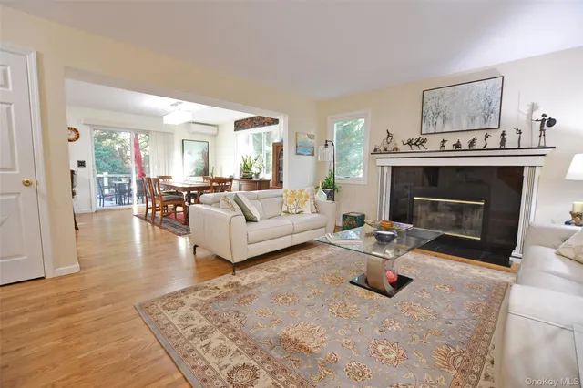 a kitchen with stainless steel appliances granite countertop a stove a sink dishwasher and white cabinets with wooden floor