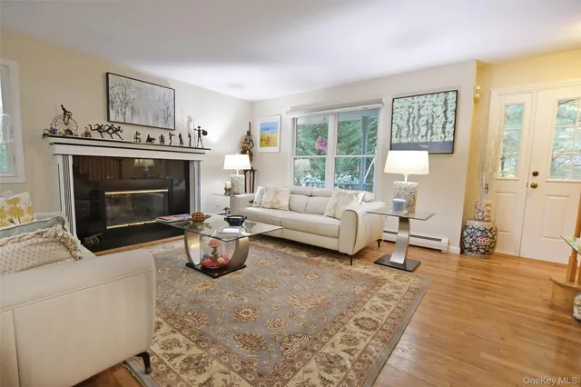 a kitchen with stainless steel appliances granite countertop a stove a refrigerator a microwave a sink a dining table and chairs with wooden floor