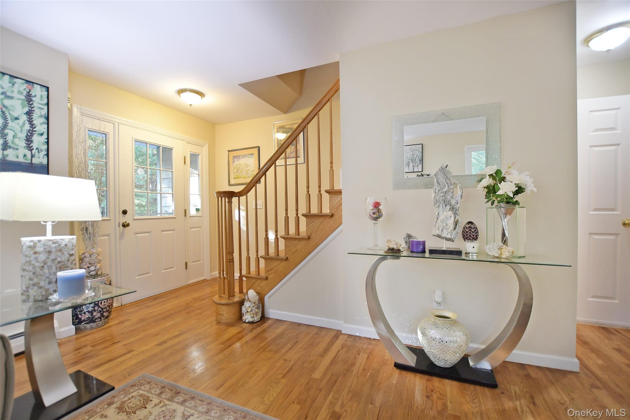 64 Glen Road Baiting Hollow, NY 11933 - Photo 7 of 46 Foyer featuring light wood-style flooring and stairs