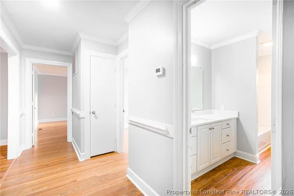 a view of a hallway with wooden floor