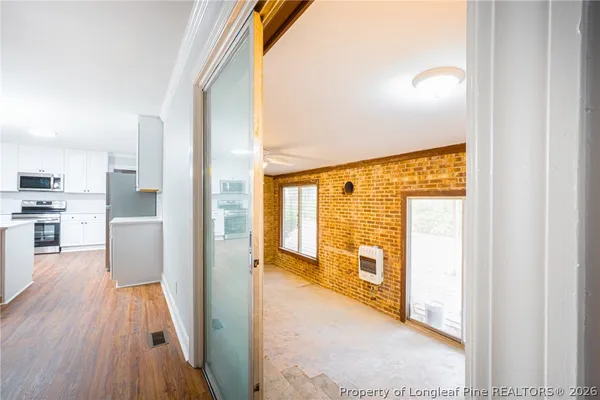 a view of a kitchen with a stove top oven
