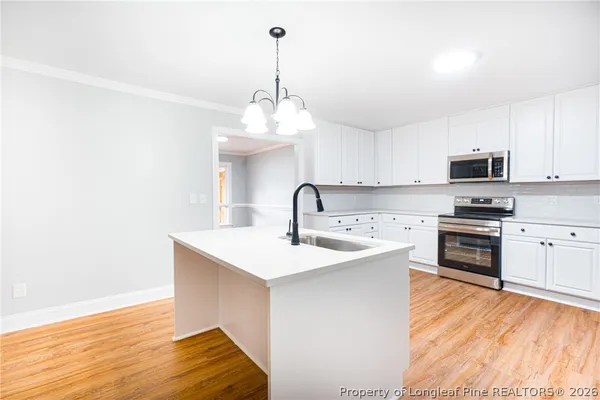 a kitchen with stainless steel appliances a sink stove and refrigerator