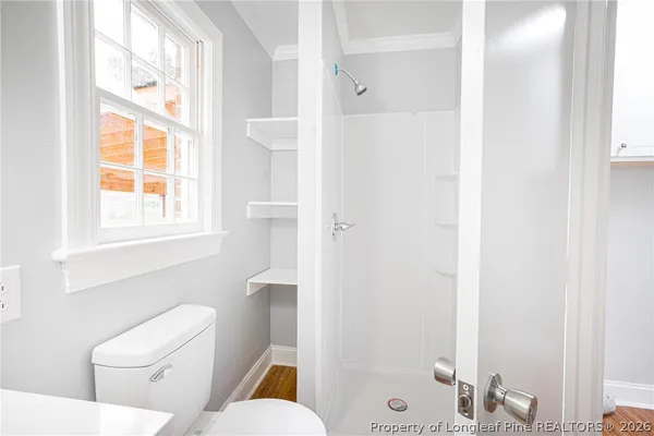 a white toilet sitting next to a bathroom sink