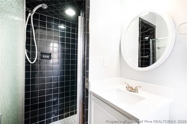 a bathroom with a sink vanity and a mirror