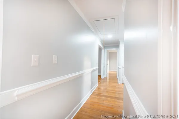 a view of a hallway with wooden floor
